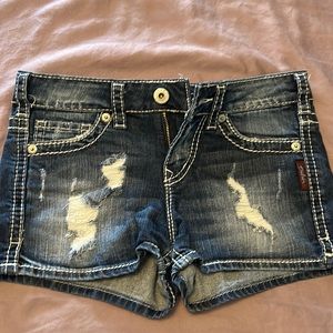 Women’s Silver distressed denim shorts.  Size 26.